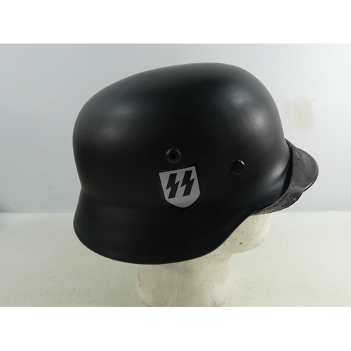 311 - A REENACTOR'S NAZI GERMANY BLACK PAINTED METAL HELMET AND LINER