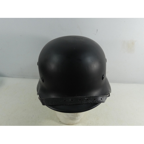 311 - A REENACTOR'S NAZI GERMANY BLACK PAINTED METAL HELMET AND LINER