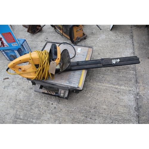 704 - TILE CUTTER AND HEDGE TRIMMER IN WORKING ORDER  NO VAT