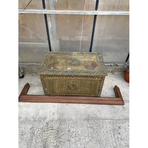 1527 - A LARGE BRASS COVERED STORAGE TRUNK AND A WOODEN FIRE FENDER