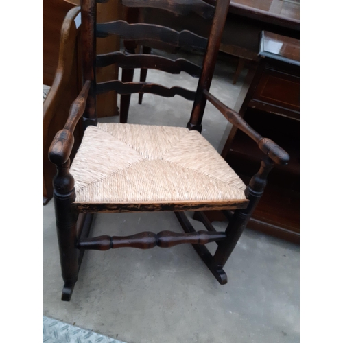 2623 - A 19TH CENTURY ELM LADDER BACK ROCKING CHAIR WITH RUSH SEAT