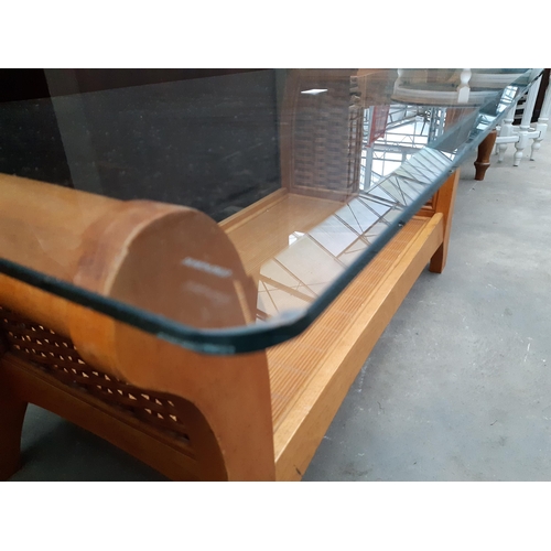 2627 - A HARDWOOD AND RATTAN COFFEE TABLE WITH GLASS TOP, 42