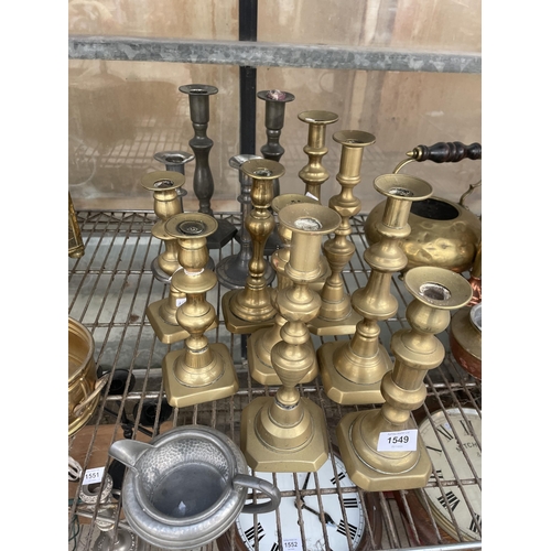 1549 - A LARGE QUANTITY OF BRASS AND SILVER PLATED CANDLE STICKS