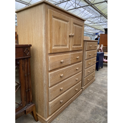 2792 - A LIMED OAK T.V. CABINET WITH SLIDING TOP DOORS AND DRAWERS TO BASE, 39.5