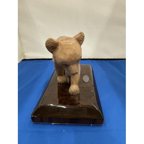 10 - A CARVED BEAR ON A PLINTH WITH PLAQUE STATING ROLLS ROYCE MOTOR CARS INC GRINDELWALD 1990