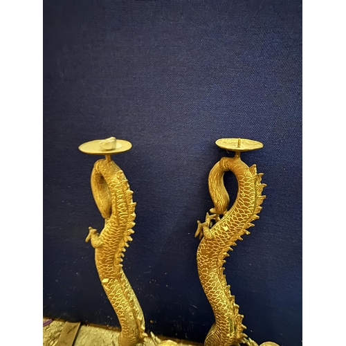 20 - A PAIR OF DECORATIVE BRASS CHINESE DRAGON CANDLE HOLDERS