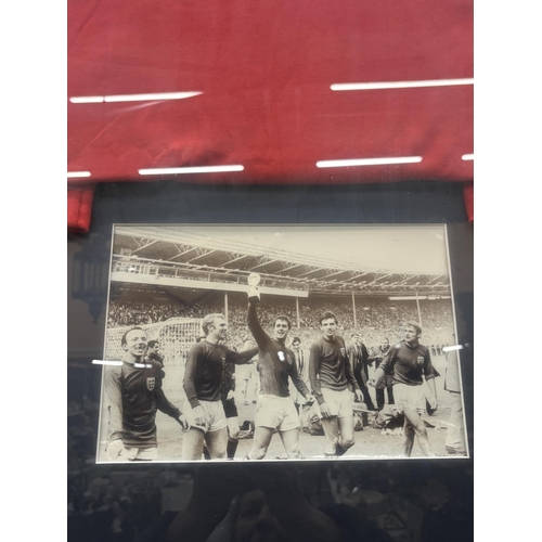 61 - A FRAMED ENGLAND 1966 REPLICA SHIRT SIGNED BY JACKIE CHARLTON, NOBBY STILES AND ROGER HUNT. VENDOR S... 