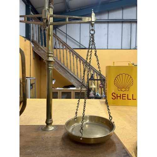 66 - A SET OF BRASS BALANCE SCALES WITH BRASS PAINS ON A WOODEN BASE