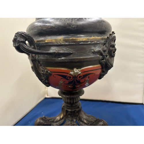 68 - A NEOCLASSICAL BRONZE TWIN HANDLED LIDDED URN ON TRIPOD LION CLAW FEET