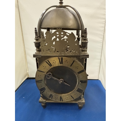 90 - A VERY HEAVY BRASS LANTERN CLOCK WITH KEY