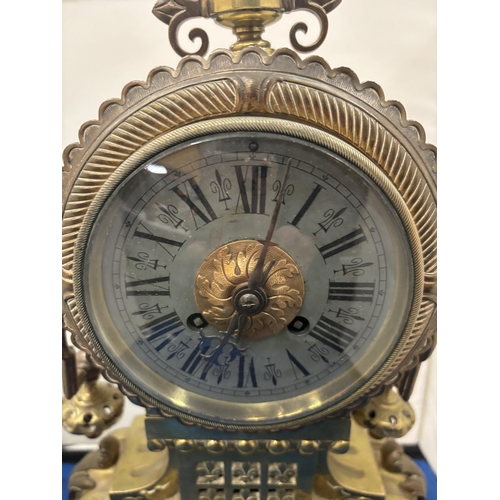 91 - A VINTAGE HEAVY BRASS MANTLE CLOCK WITH WHITE METAL FACE AND ROMAN NUMERALS