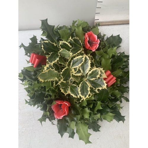 19 - TWO CHRISTMAS WREATHS WITH HOLLY, RIBBON AND CHRISTMAS ACCESSORIES ON A MOSS RING. APPROX 30CM IN DI... 