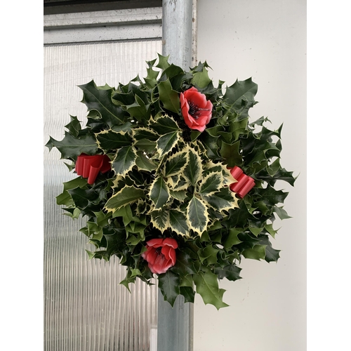 19 - TWO CHRISTMAS WREATHS WITH HOLLY, RIBBON AND CHRISTMAS ACCESSORIES ON A MOSS RING. APPROX 30CM IN DI... 