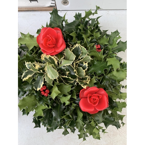 22 - TWO CHRISTMAS WREATHS WITH HOLLY AND CHRISTMAS ACCESSORIES ON A MOSS RING. APPROX 30CM IN DIAMETER T... 