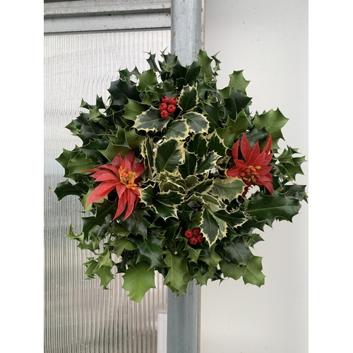 22 - TWO CHRISTMAS WREATHS WITH HOLLY AND CHRISTMAS ACCESSORIES ON A MOSS RING. APPROX 30CM IN DIAMETER T... 