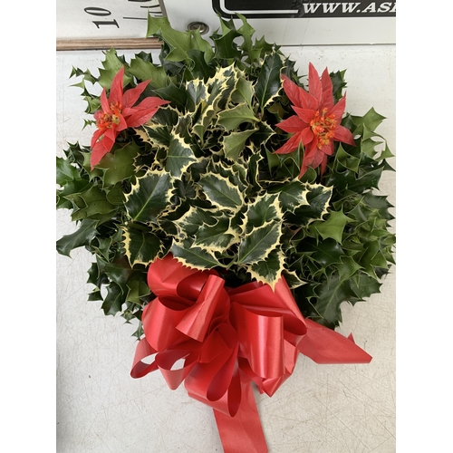 9 - TWO CHRISTMAS WREATHS WITH HOLLY, RIBBON AND CHRISTMAS ACCESSORIES ON A MOSS RING. APPROX 30CM IN DI... 