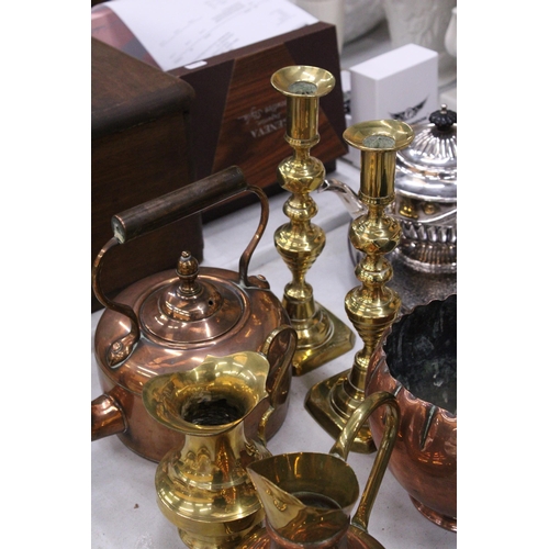 187 - A QUANTITY OF BRASS AND COPPERWARE TO INCLUDE LARGE CANDLESTICKS, STOVE KETTLE, PLANTER, ETC.,