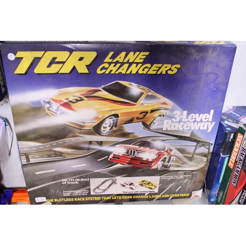 490 - THREE CAR RACING GAMES TO INCLUDE, TCR LANE CHANGERS, 3-LEVEL RACEWAY, TRANSFORMERS ELECTRIC RACING ... 