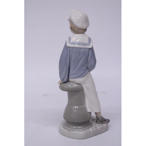 838 - A LLADRO FIGURE OF A SAILOR BOY WITH A TOY SAILBOAT