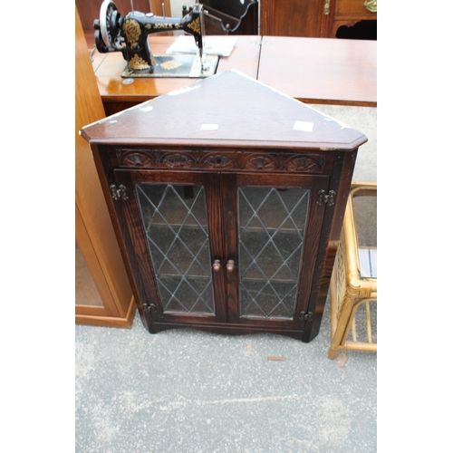 2943 - AN OAK JAYCEE GLAZED AND LEADER CORNER CUPBOARD