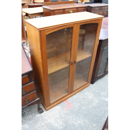 2944 - A TEAK TWO DOOR GLAZED BOOKCASE BEARING GEO.E. BRYANT AND SONS LTD LABEL, 35