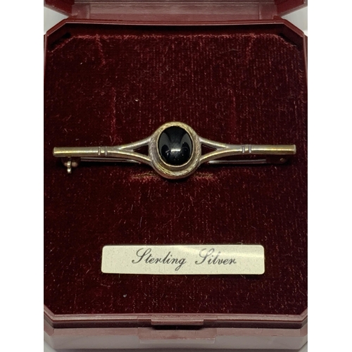 606 - A MARKED STERLING SILVER PIN BROOCH WITH BLACK STONE IN A PRESENTATION BOX