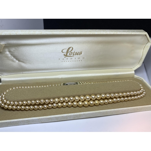 718 - A DOUBLE STRING OF LOTUS PEARLS IN A PRESENTATION BOX