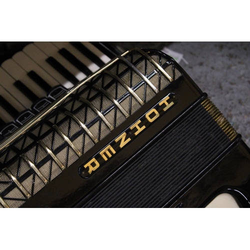 217 - A VINTAGE HOHNER ATLANTIC PIANO ACCORDIAN IN A CASE