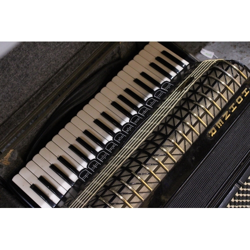 217 - A VINTAGE HOHNER ATLANTIC PIANO ACCORDIAN IN A CASE