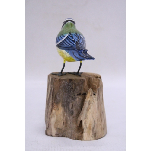 251 - A WOODEN BLUE TIT ON A WOODEN BASE, HEIGHT 15CM