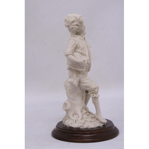 279 - A FIGURE OF A BOY ON A WOODEN PLINTH, HEIGHT 16CM