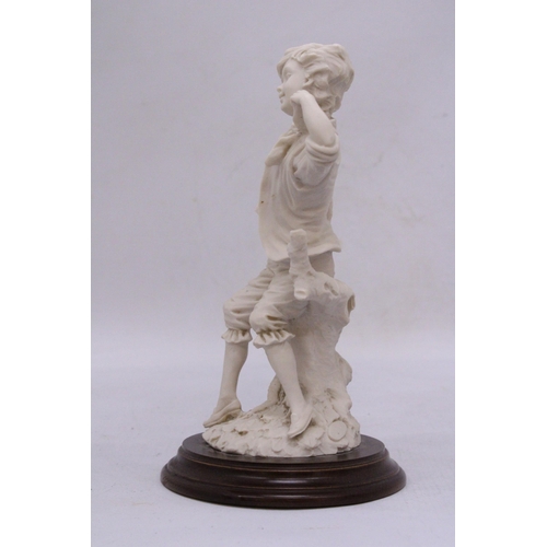 279 - A FIGURE OF A BOY ON A WOODEN PLINTH, HEIGHT 16CM