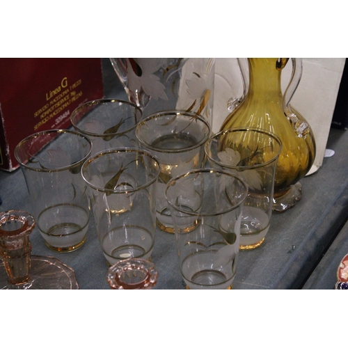 300 - A GOLD AND CLEAR JUG WITH MATCHING GLASSES, AN EMERALD GREEN ENAMELLED VASE, PINK GLASS CANDLESTICKS... 