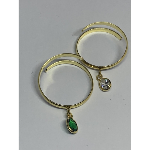 554 - FOUR MARKED SILVER GOLD PLATED RINGS WITH CHARMS