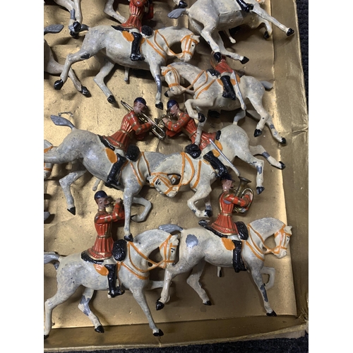 528 - A VINTAGE SET OF TWELVE BRITAINS, MOUNTED BAND OF THE FIRST LIFEGUARDS, WITH RED JACKETS