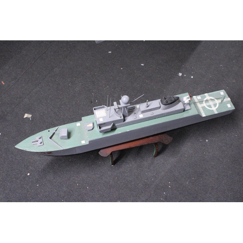 560 - A LARGE SCRATCH BUILT WAR SHIP ON A STAND, LENGTH 91CM