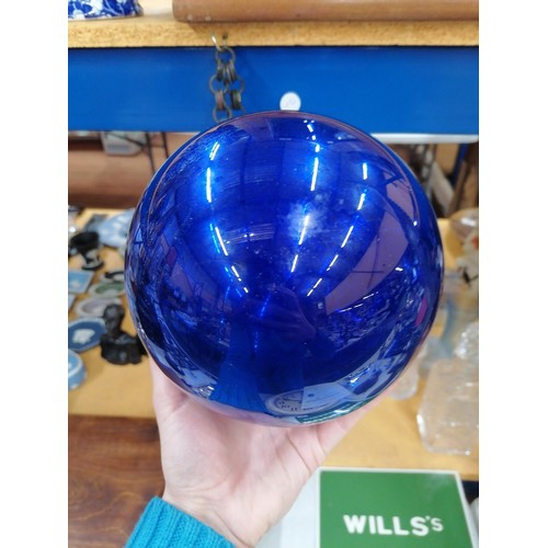 76 - A LARGE VICTORIAN MIRRORED BLUE GLASS WITCHES BALL ON A CHAIN, CIRCUMFERENCE APPROX 51CM