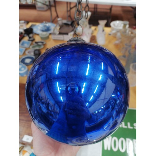 76 - A LARGE VICTORIAN MIRRORED BLUE GLASS WITCHES BALL ON A CHAIN, CIRCUMFERENCE APPROX 51CM