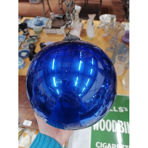 76 - A LARGE VICTORIAN MIRRORED BLUE GLASS WITCHES BALL ON A CHAIN, CIRCUMFERENCE APPROX 51CM