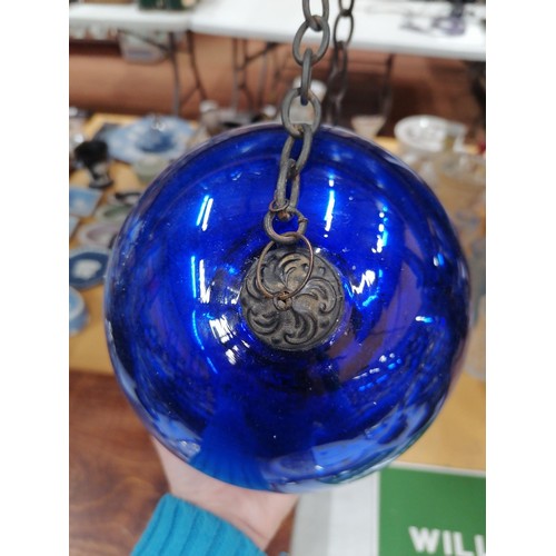 76 - A LARGE VICTORIAN MIRRORED BLUE GLASS WITCHES BALL ON A CHAIN, CIRCUMFERENCE APPROX 51CM