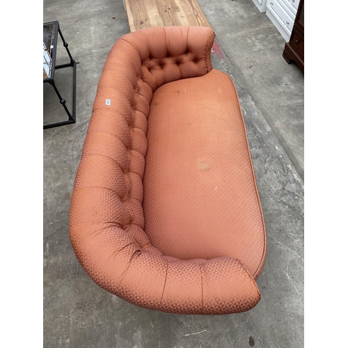 3068 - A LATE VICTORIAN BUTTON BACK COUCH ON EBONISED TURNED LEGS