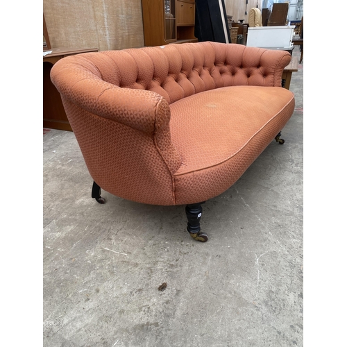 3068 - A LATE VICTORIAN BUTTON BACK COUCH ON EBONISED TURNED LEGS