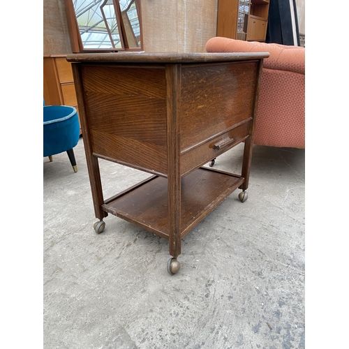 3069 - A MID 20TH CENTURY OAK SEWING BOX/TABLE ON CASTERS