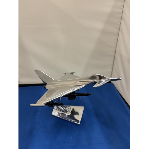 21 - A CHROME TYPHOON FIGHTER JET ON A BASE