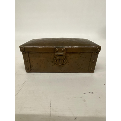 103 - AN ARTS AND CRAFTS HAMMERED COPPER AND RIVETED TRUNK STYLE BOX 16CM LONG