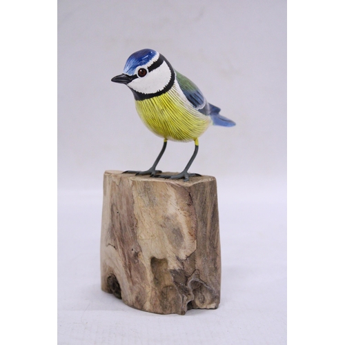 251 - A WOODEN BLUE TIT ON A WOODEN BASE, HEIGHT 15CM