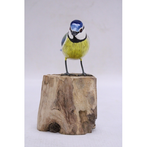 251 - A WOODEN BLUE TIT ON A WOODEN BASE, HEIGHT 15CM