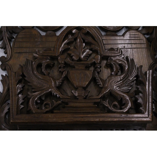 262 - A CARVED MAHOGANY WALL HANGING MAGAZINE/LETTER RACK WITH GRIFFIN DESIGN, 36CM X 40CM