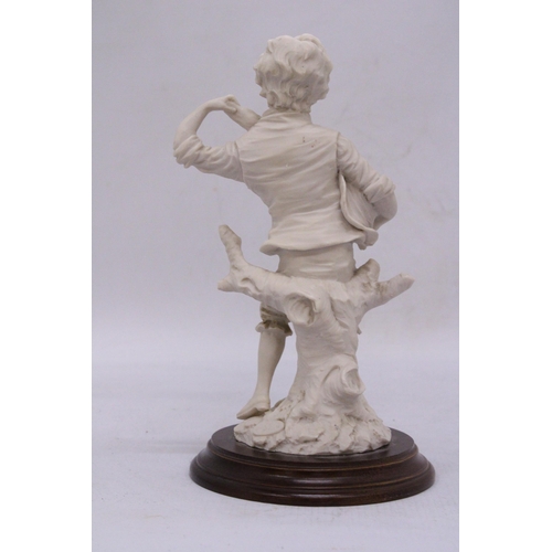 279 - A FIGURE OF A BOY ON A WOODEN PLINTH, HEIGHT 16CM