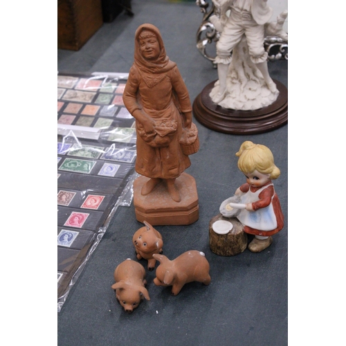 280 - A TERRACOTTA FIGURE OF A LADY, THREE PIGS AN A YOUNG GIRL